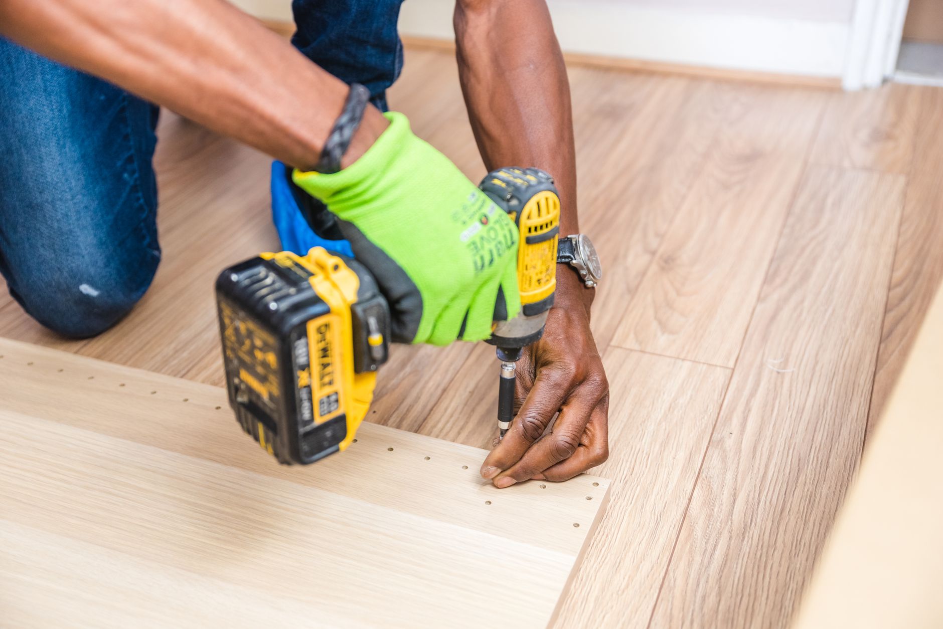 Handyman drilling wood indoors during a Port St Lucie repair job